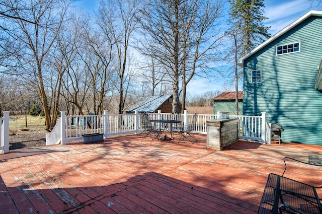 wooden terrace with outdoor dining space