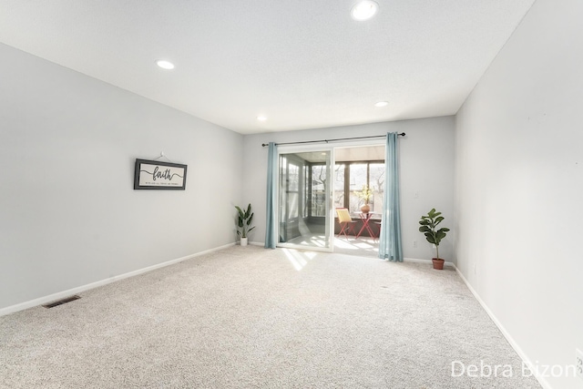 unfurnished room with light colored carpet, recessed lighting, baseboards, and visible vents