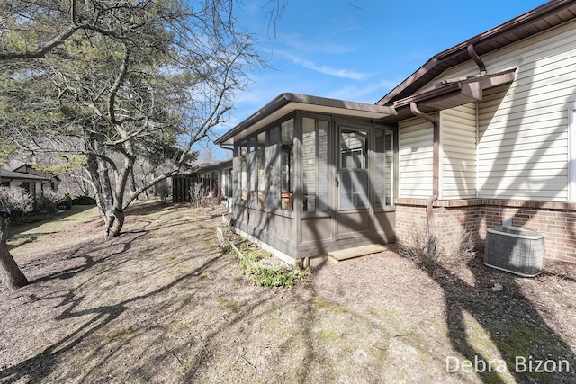 view of home's exterior featuring central AC and a sunroom