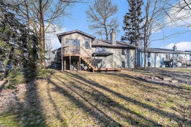 back of house with stairway, a wooden deck, a gazebo, a chimney, and a yard