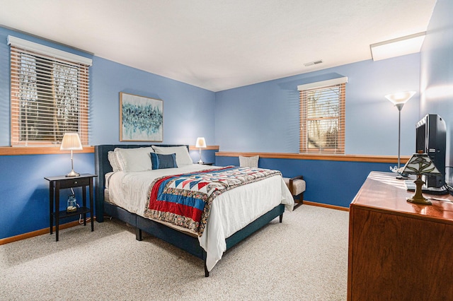 bedroom featuring visible vents, baseboards, and carpet flooring