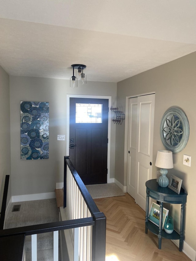 entrance foyer with visible vents and baseboards