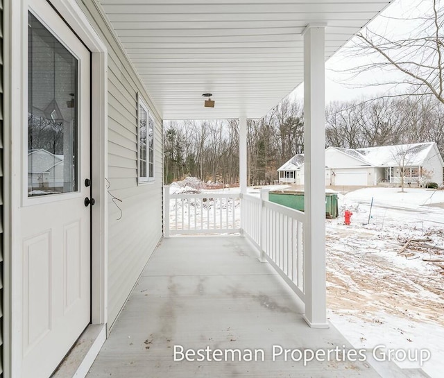 snow covered patio with covered porch