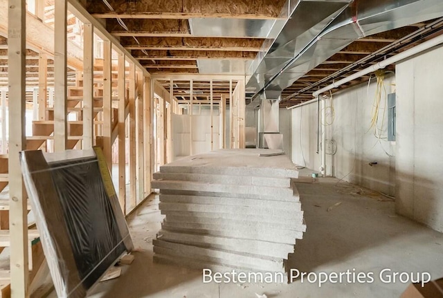 unfinished basement featuring electric panel