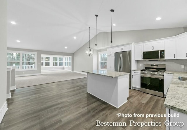 kitchen with dark wood finished floors, open floor plan, white cabinetry, and stainless steel appliances