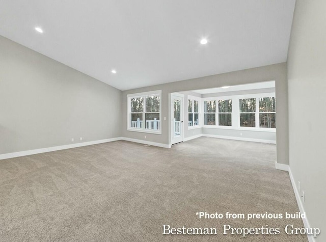 unfurnished living room featuring vaulted ceiling, carpet flooring, recessed lighting, and baseboards