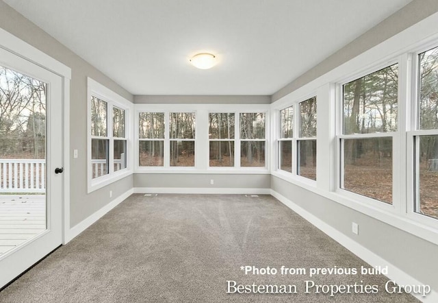 unfurnished sunroom featuring visible vents