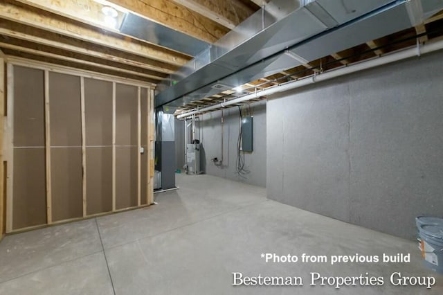 unfinished basement featuring gas water heater and electric panel