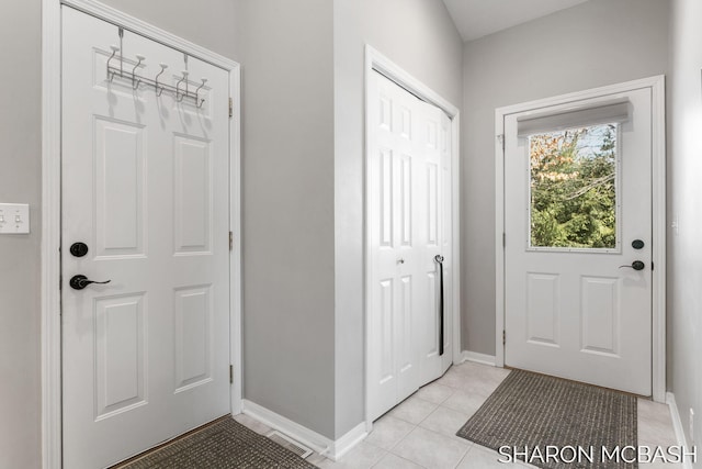 entryway with visible vents, baseboards, and light tile patterned flooring