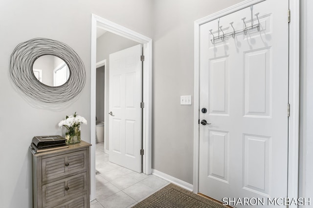 interior space with light tile patterned floors and baseboards