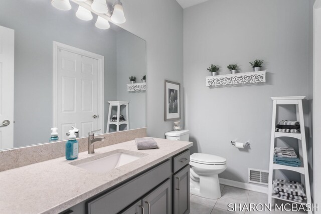 bathroom featuring visible vents, toilet, tile patterned flooring, a chandelier, and vanity