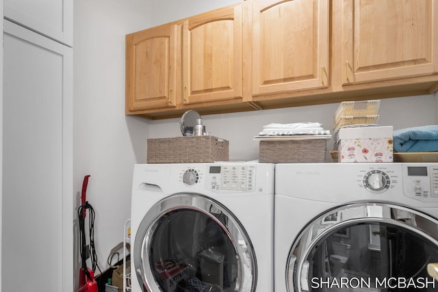 clothes washing area with cabinet space and washing machine and clothes dryer