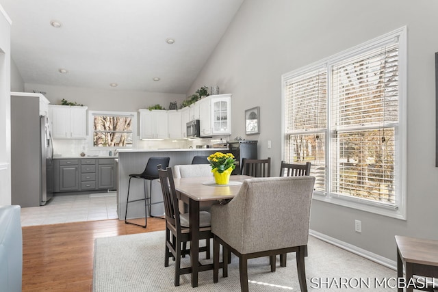 dining area with a wealth of natural light, recessed lighting, and light wood-style floors