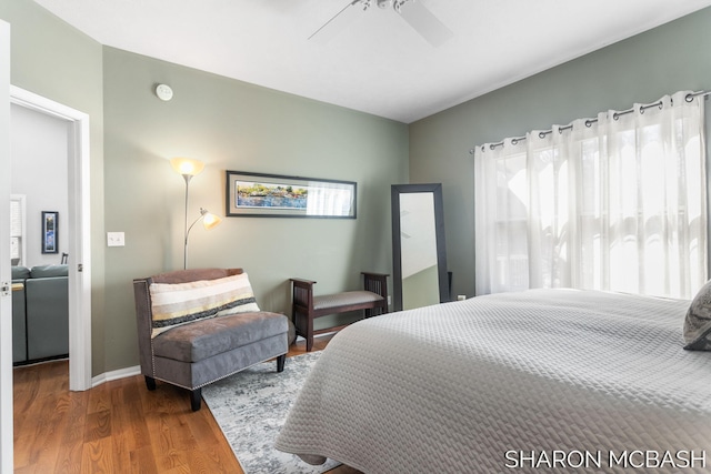 bedroom featuring baseboards, ceiling fan, and wood finished floors