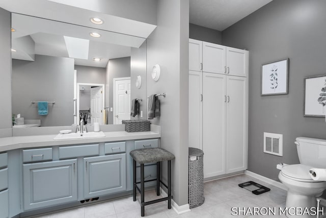 full bath with visible vents, baseboards, toilet, tile patterned floors, and vanity