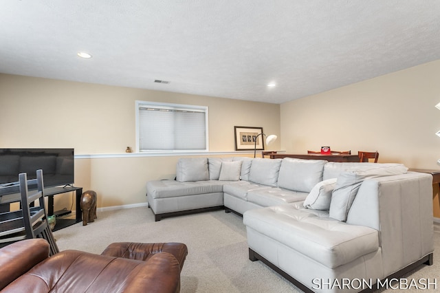 carpeted living room with visible vents, recessed lighting, a textured ceiling, and baseboards