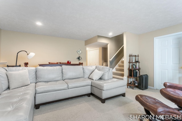 living area featuring stairway, baseboards, recessed lighting, a textured ceiling, and carpet flooring