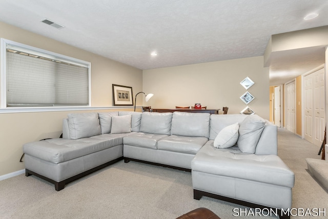 carpeted living room with recessed lighting, visible vents, and baseboards