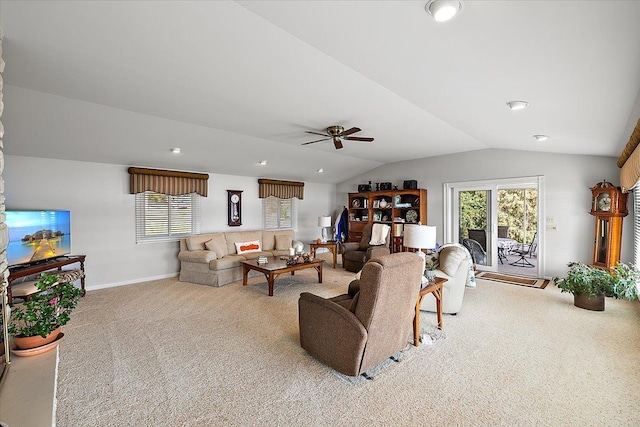 carpeted living area featuring baseboards, ceiling fan, and vaulted ceiling