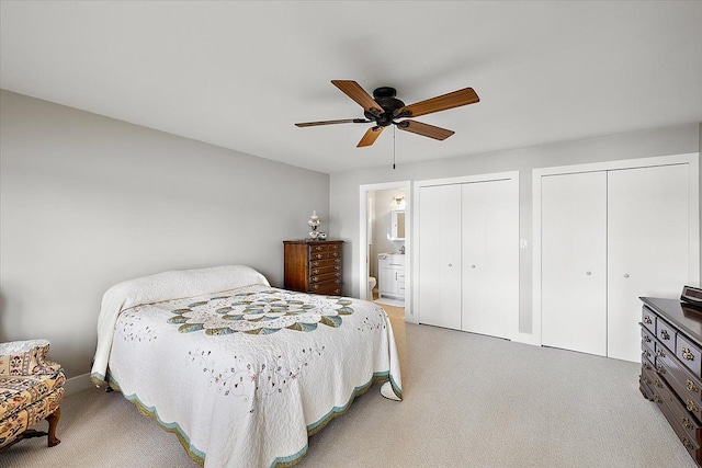 bedroom featuring ceiling fan, multiple closets, and connected bathroom