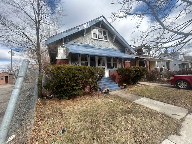 bungalow featuring brick siding