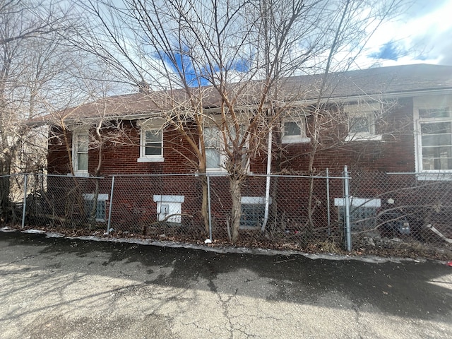 exterior space featuring a fenced front yard and brick siding