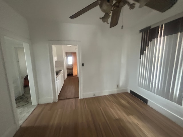 interior space featuring baseboards and wood finished floors