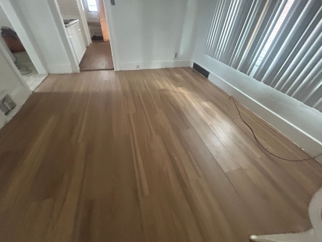 interior space with visible vents, baseboards, and light wood-style floors