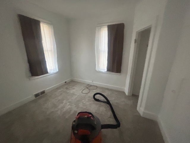 unfurnished bedroom featuring baseboards, visible vents, and carpet floors