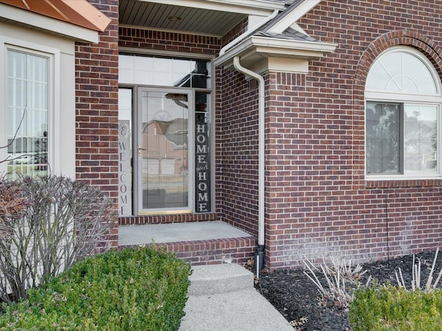 entrance to property featuring brick siding