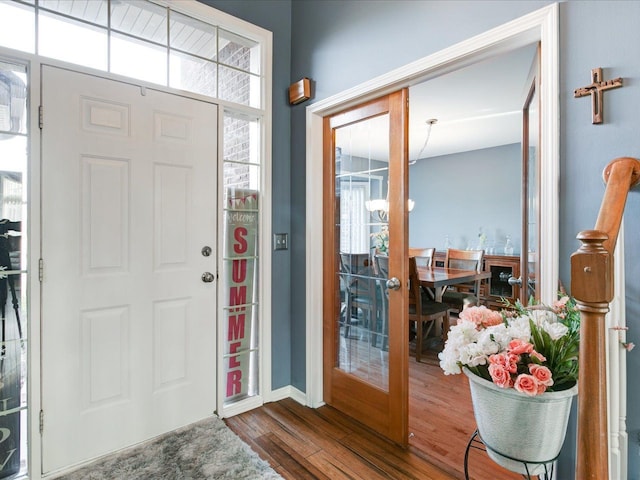 entrance foyer featuring french doors, baseboards, and dark wood-style floors