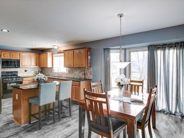 dining area featuring light wood-style flooring