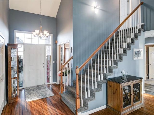 entrance foyer featuring stairs, a high ceiling, and wood finished floors