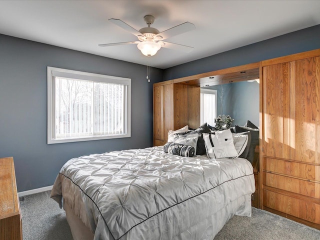 carpeted bedroom with baseboards and ceiling fan