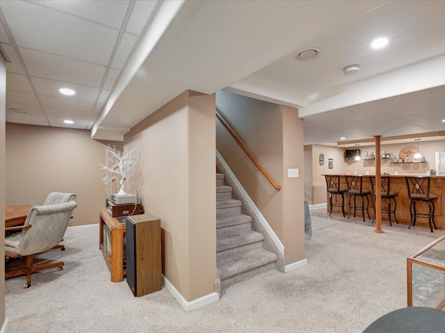 carpeted office space with bar, recessed lighting, baseboards, and a paneled ceiling