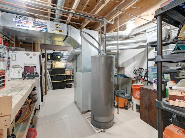 unfinished below grade area featuring a workshop area and water heater