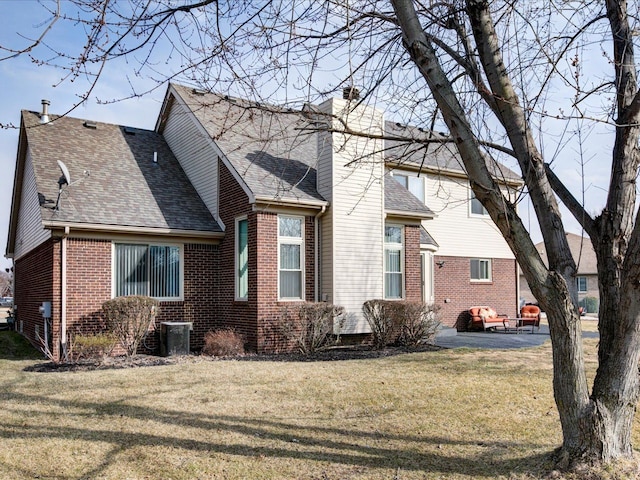 exterior space featuring brick siding, a front lawn, central air condition unit, roof with shingles, and a chimney