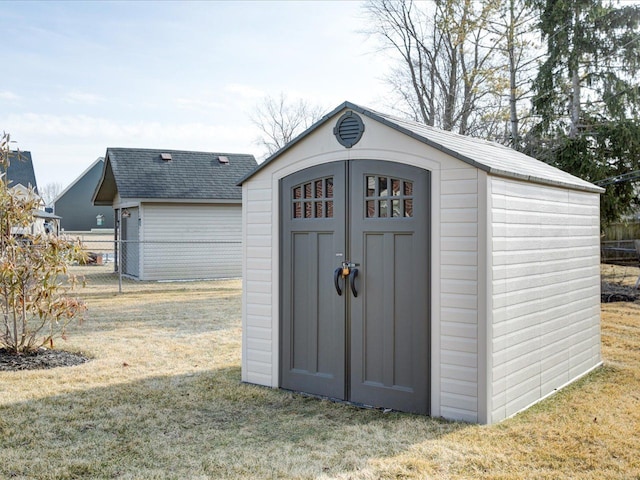 view of shed featuring fence