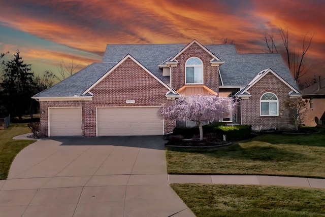 traditional-style home featuring a front lawn, concrete driveway, and brick siding