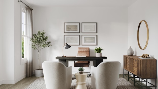 office area with a wealth of natural light, baseboards, and wood finished floors