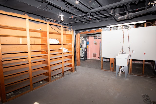 unfinished basement featuring gas water heater