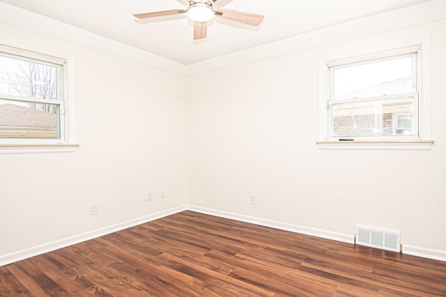 unfurnished room with visible vents, wood finished floors, baseboards, and ceiling fan