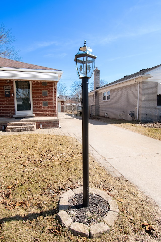 view of yard featuring driveway and fence