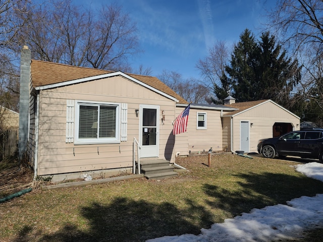 view of front facade featuring board and batten siding, a front lawn, entry steps, roof with shingles, and a chimney