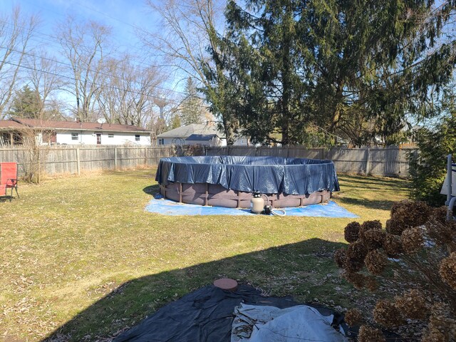 view of yard with a fenced in pool and a fenced backyard