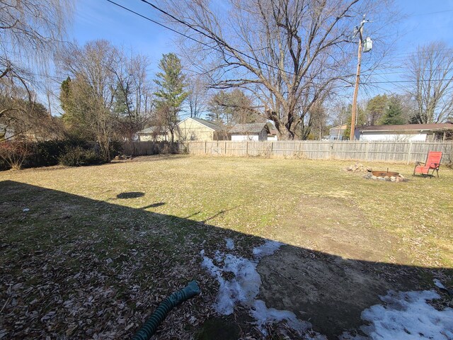 view of yard with a fenced backyard and an outdoor fire pit