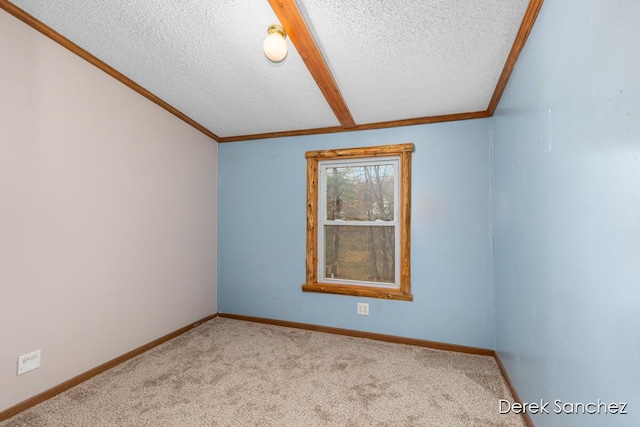 carpeted spare room featuring baseboards, a textured ceiling, and ornamental molding