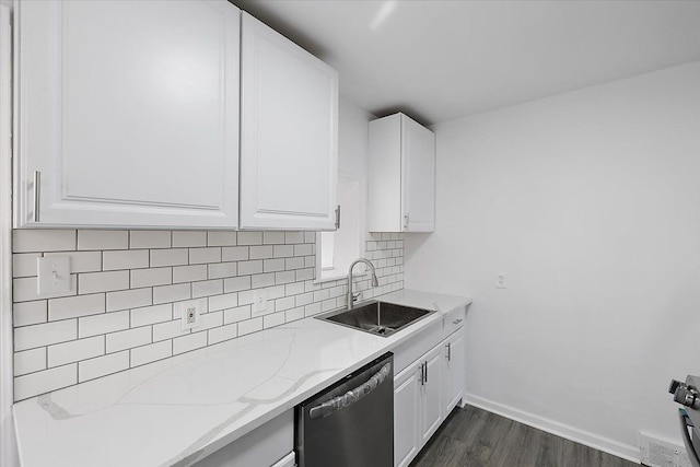 kitchen featuring dark wood-type flooring, a sink, tasteful backsplash, stainless steel dishwasher, and white cabinets