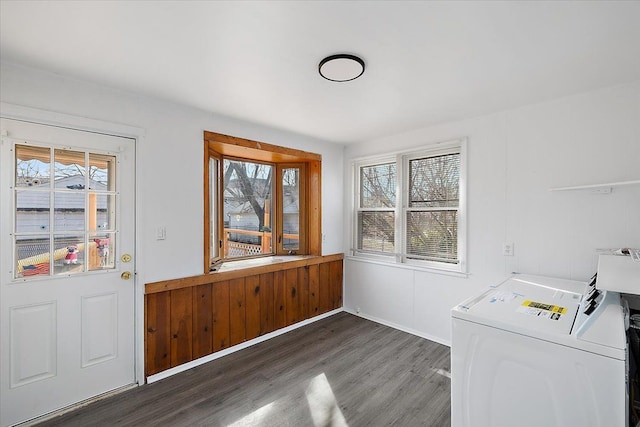 washroom featuring laundry area, wood finished floors, washing machine and dryer, and plenty of natural light