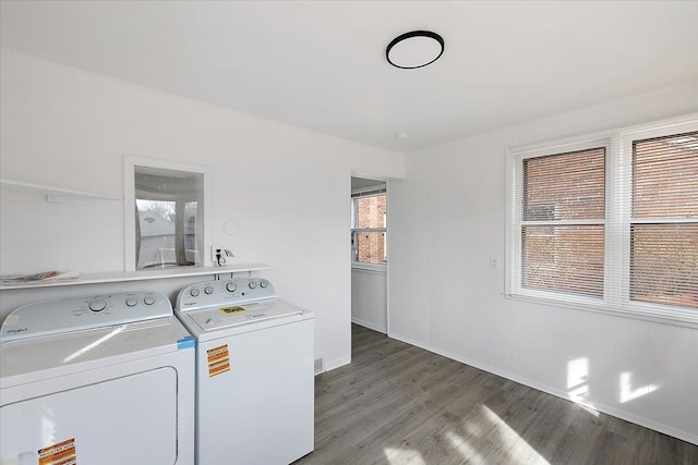 laundry area with washer and dryer, laundry area, baseboards, and light wood finished floors